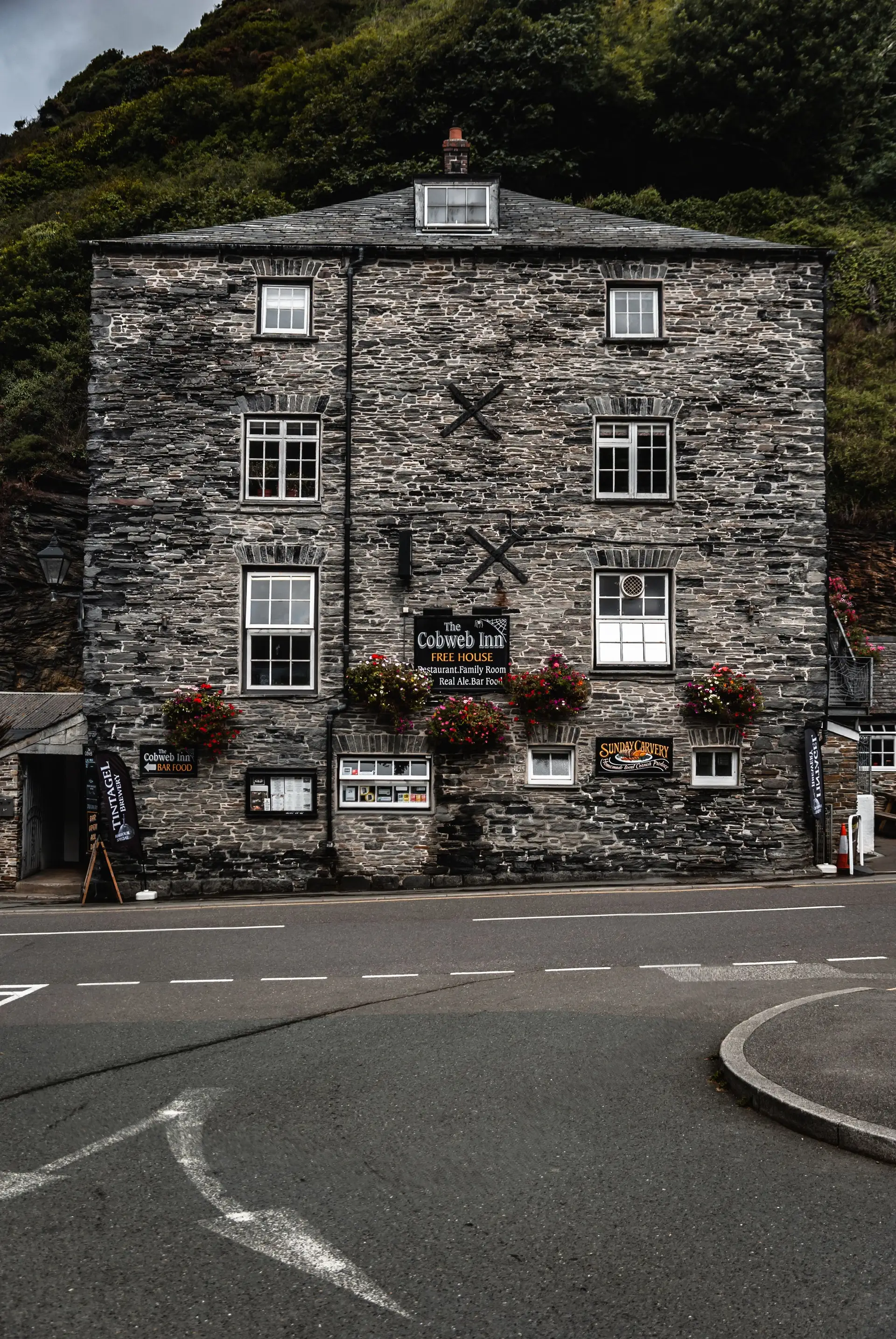 Classic British countryside stone inn with hanging floral displays