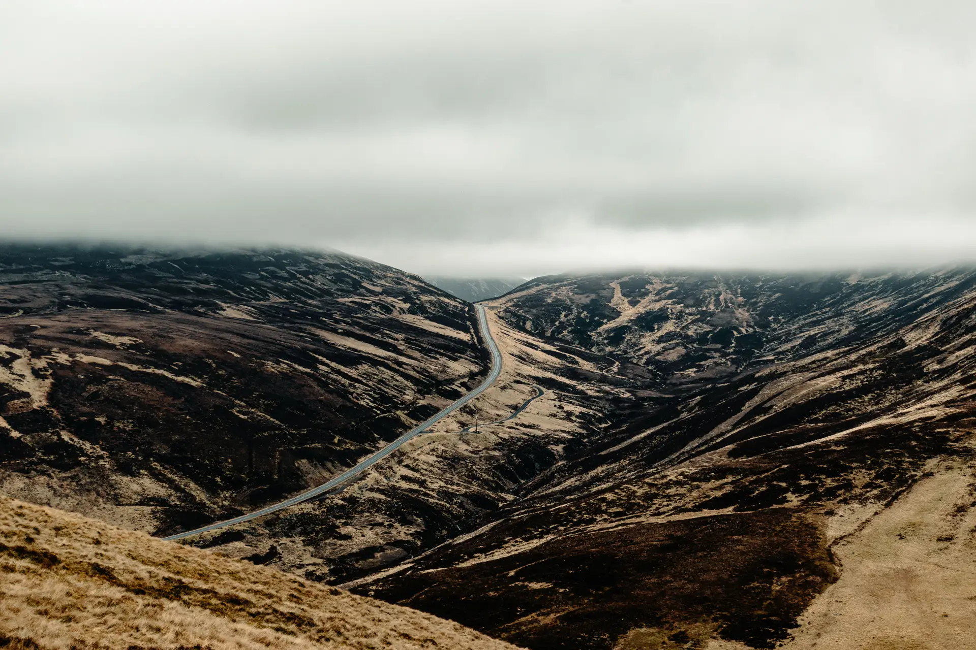 Vast dramatic highlands mountain panorama under sweeping cloud shadows