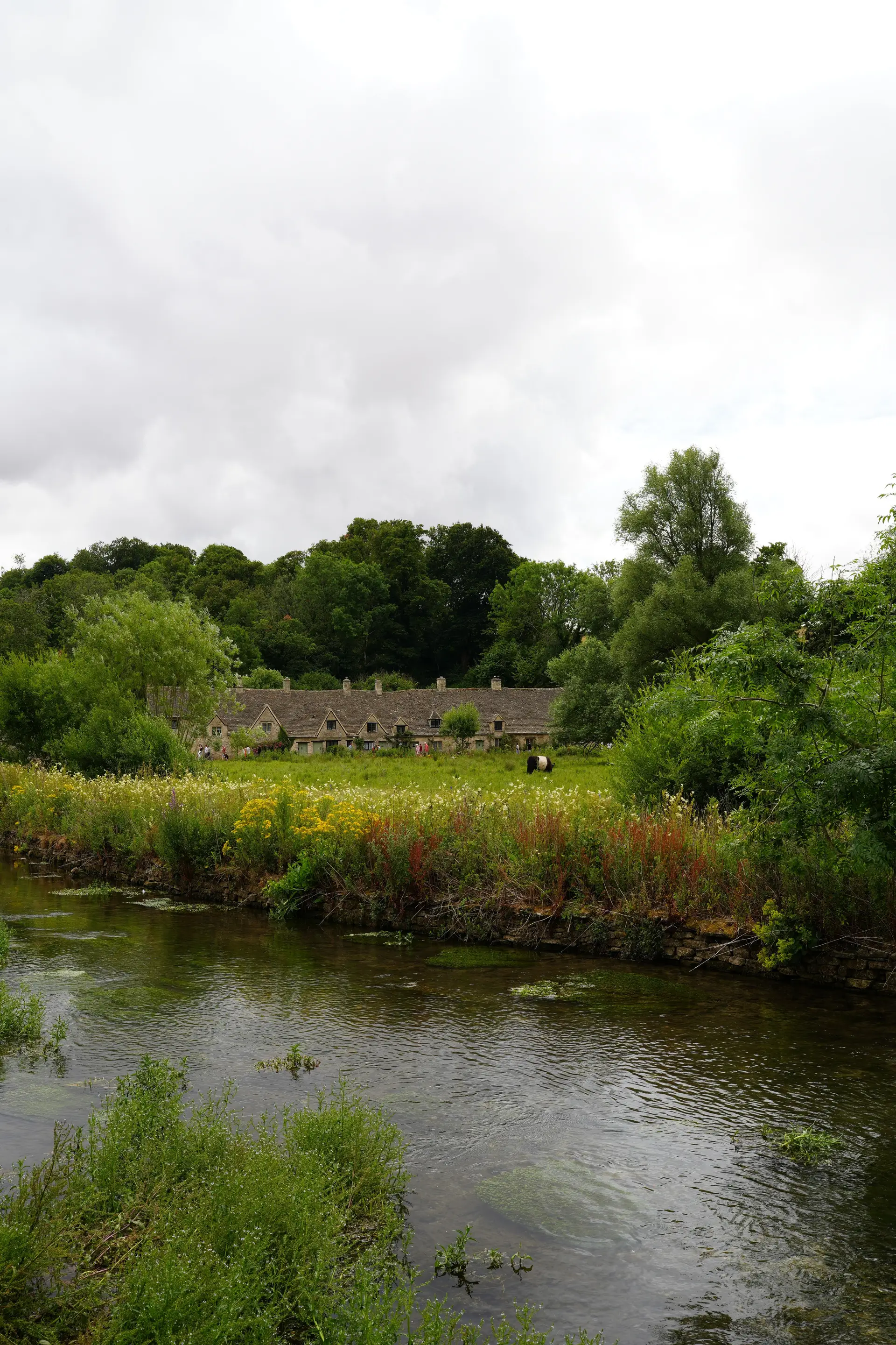 River winding through rural village with historic stone buildings