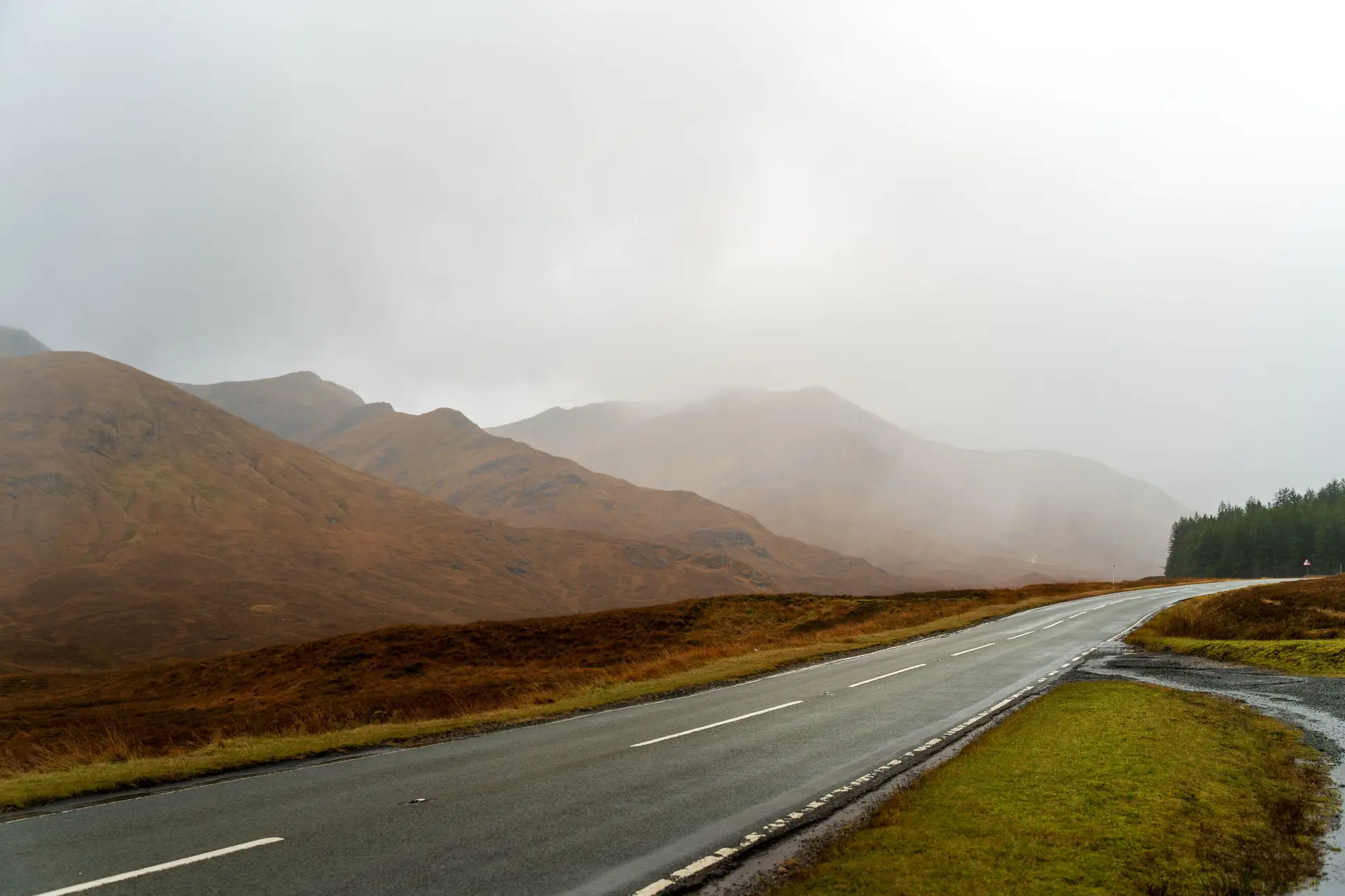 Autumn foliage framing a twisting highland mountain pass