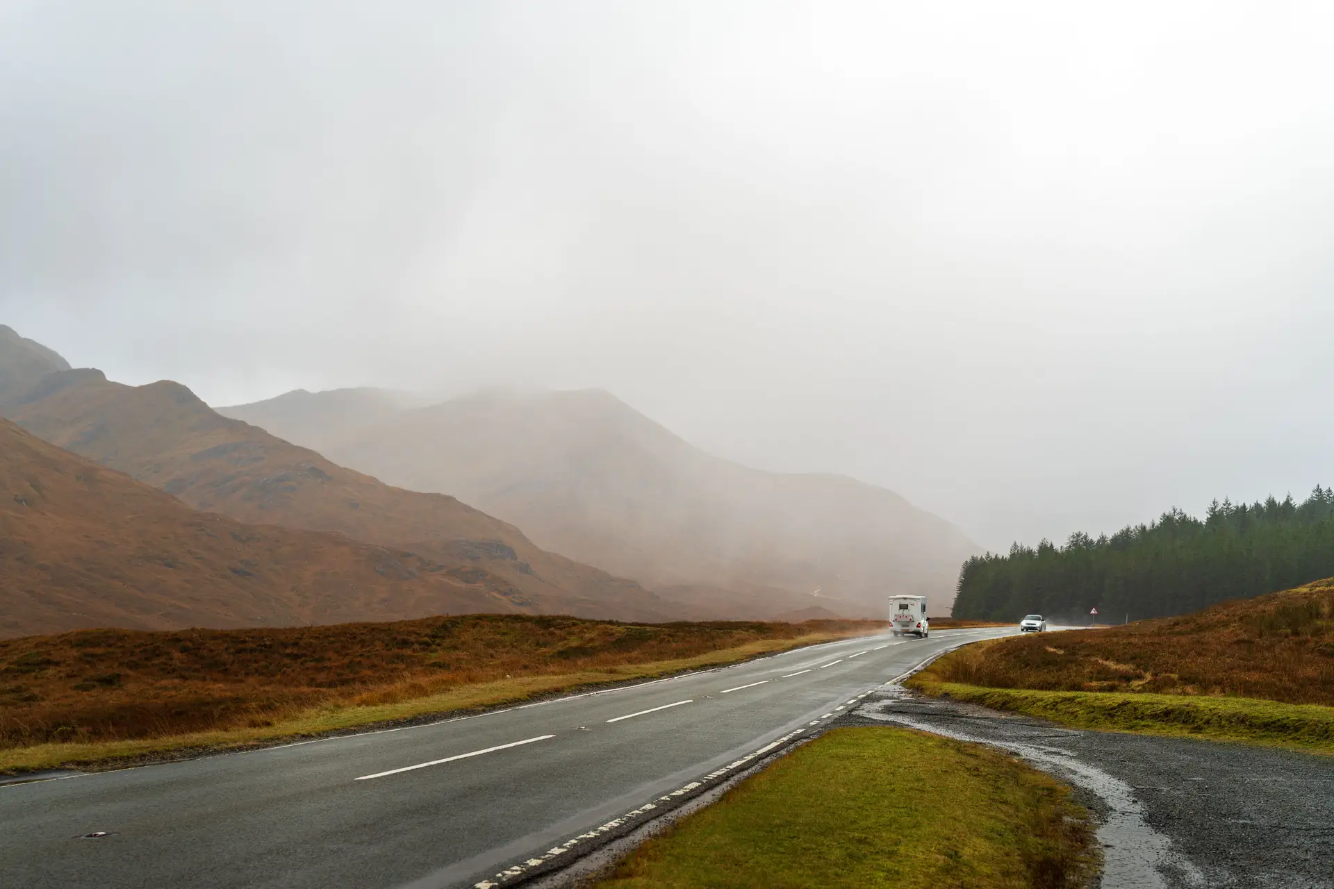 Rugged coastal Welsh hillside road facing ocean horizon