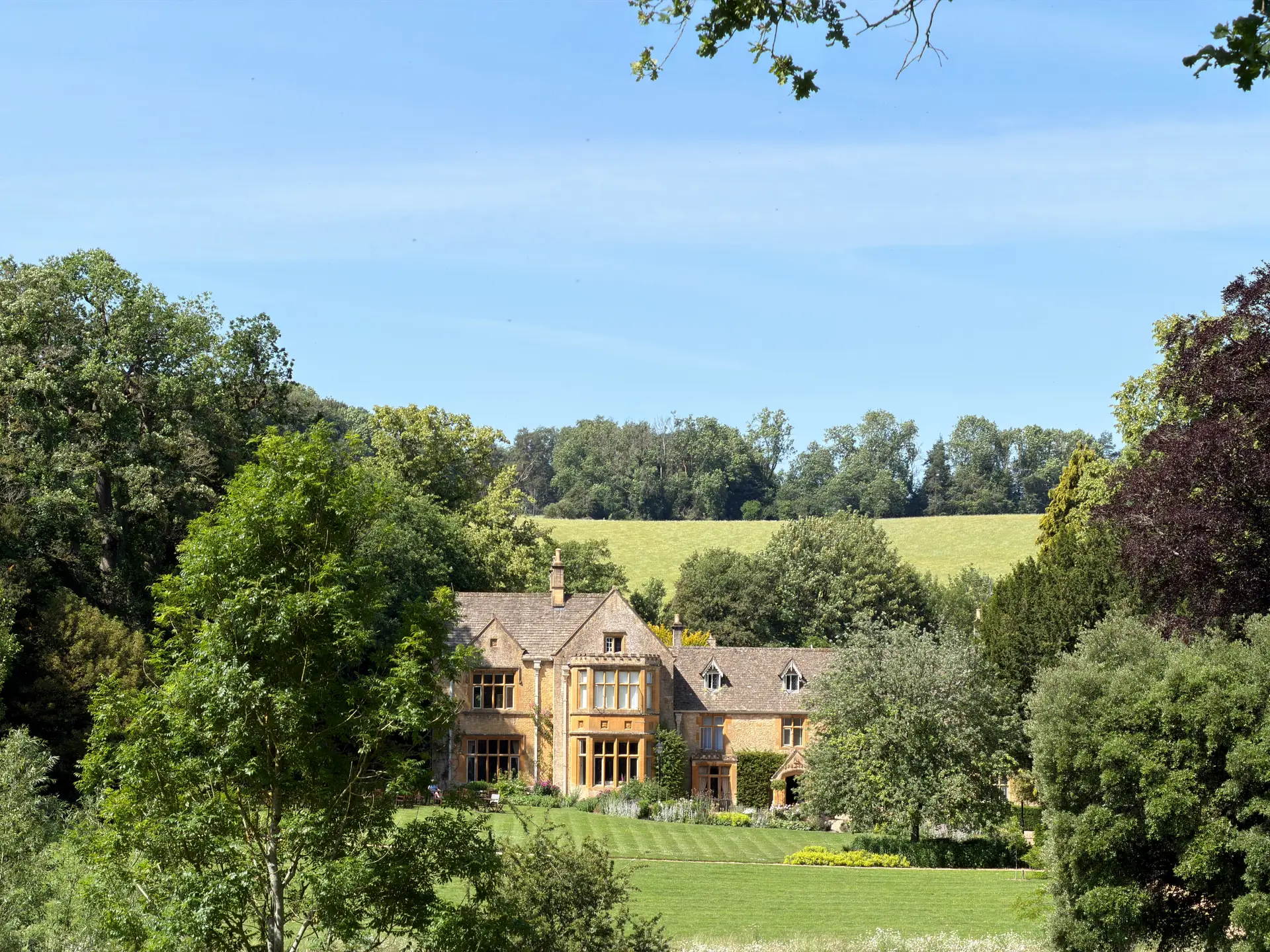Historic manor estate surrounded by lush greenery in the English countryside