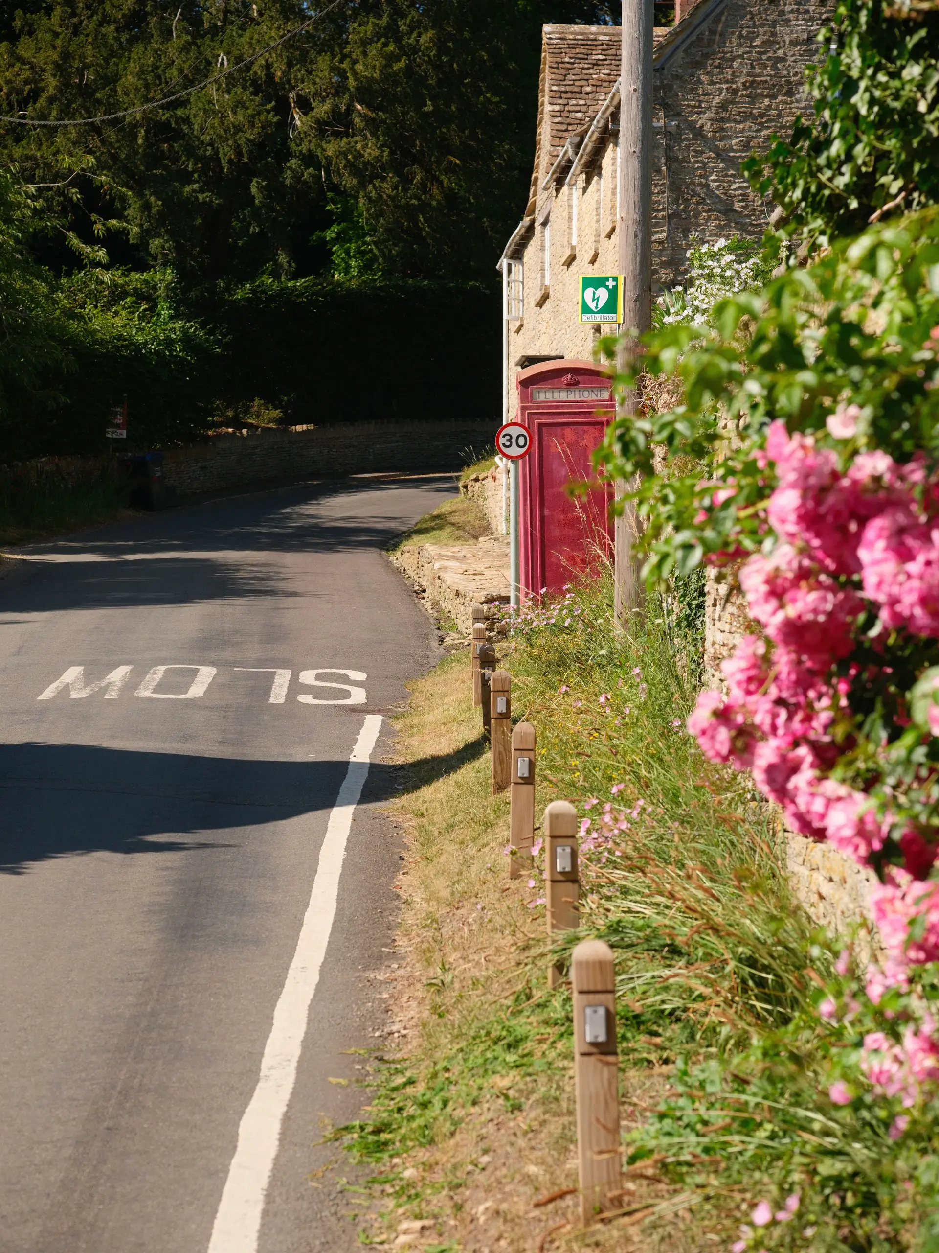 Charming lane with stone dwellings and red post box in rural Somerset