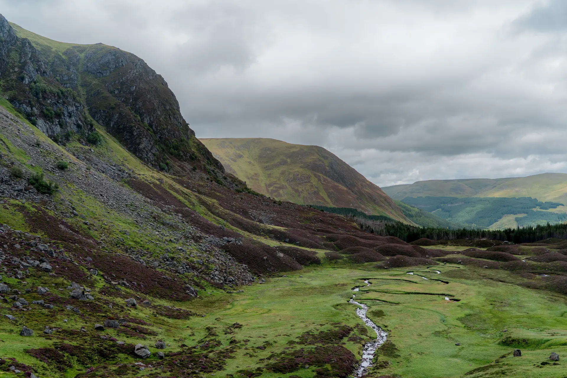 Dramatic mountain landscape under cloudy Scottish skies