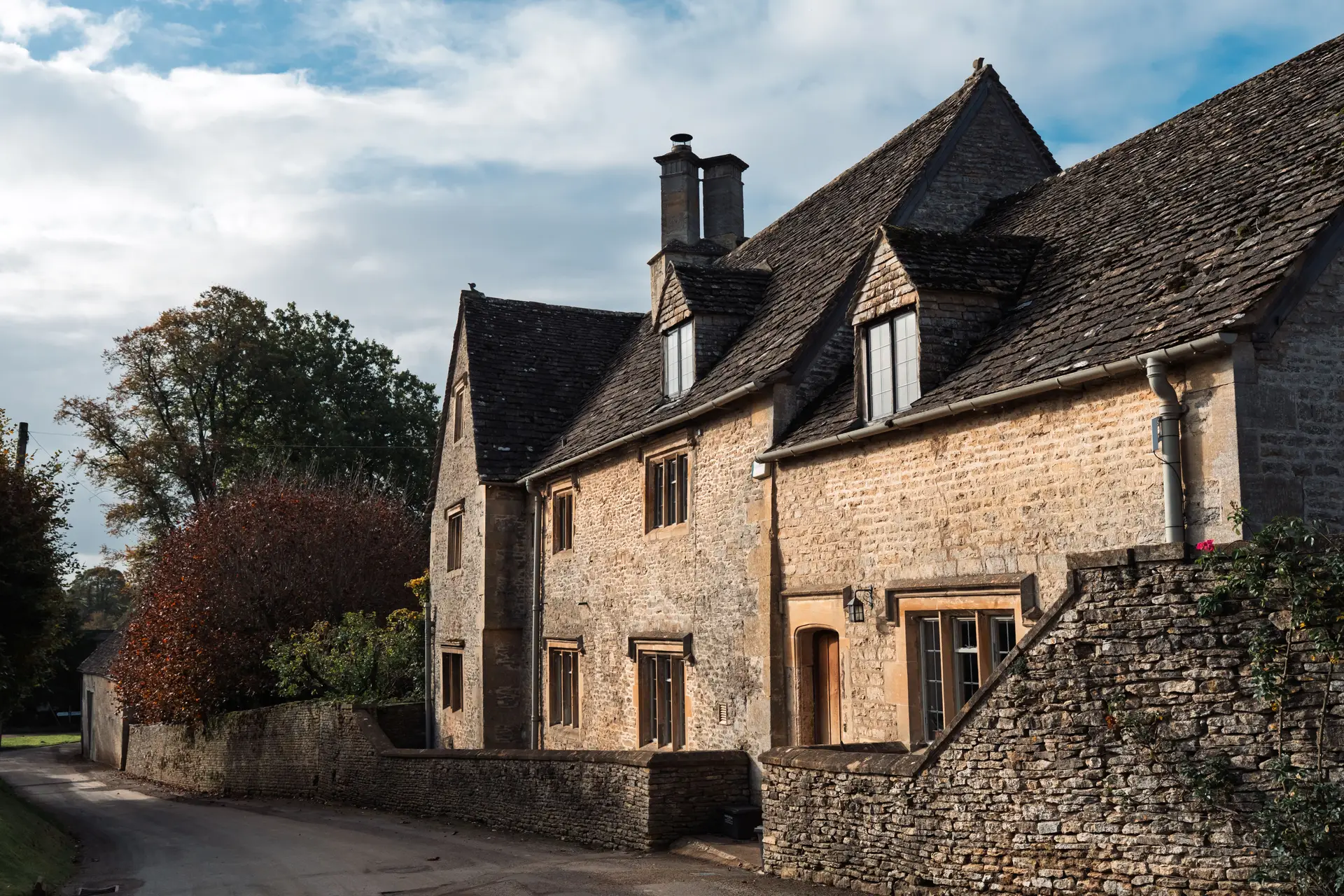 Cotswold stone house bathed in warm autumn sunshine