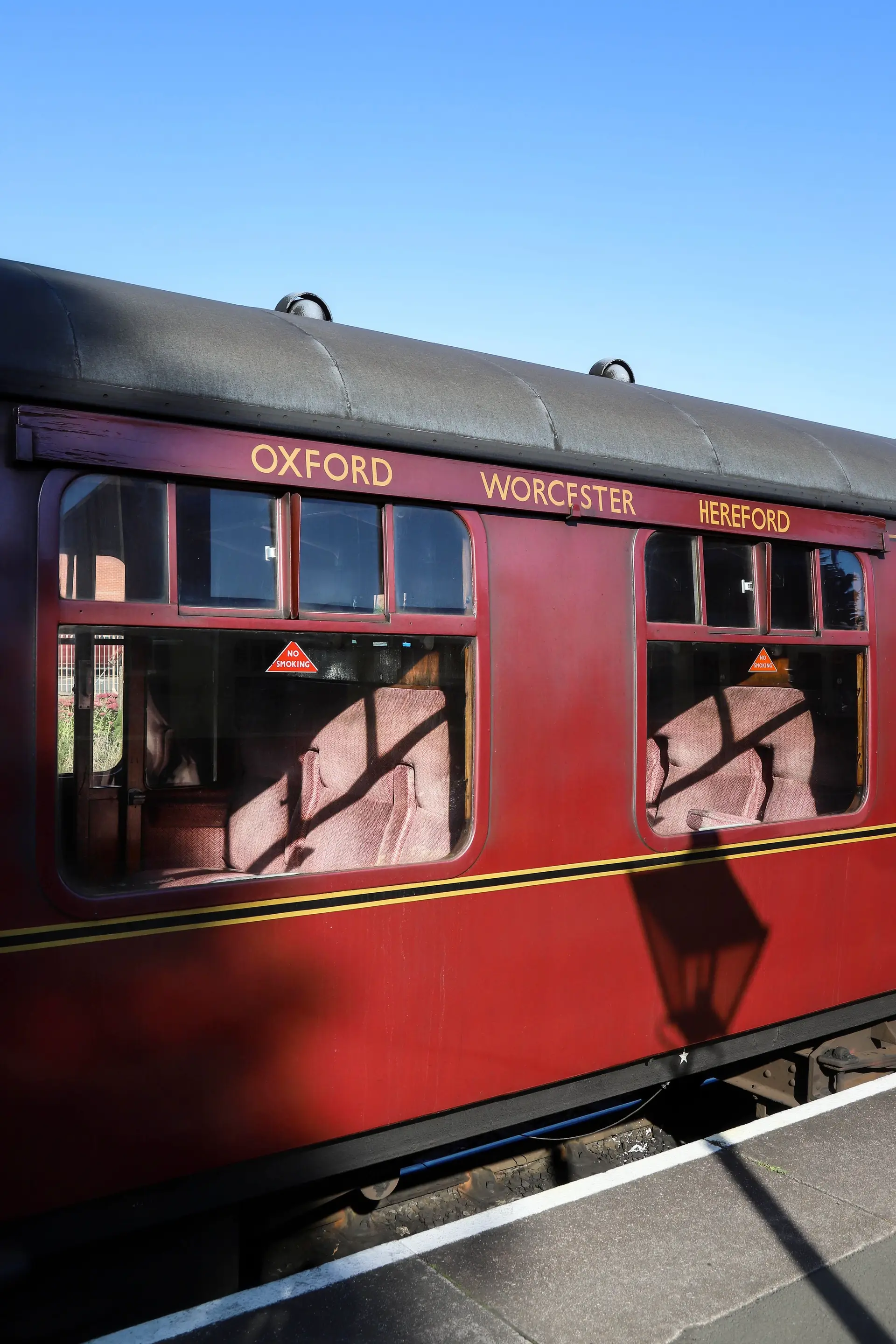 Timber panelled British passenger carriage with soft natural window illumination